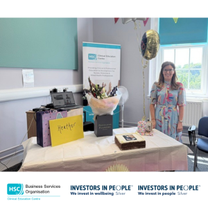 Heather Finlay at a retirement celebration event with cards, gifts, flowers and commemorative balloons.