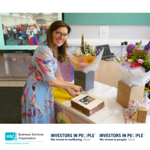 Retirement celebration at the Clinical Education Centre, showing cake-cutting alongside gifts and flowers presented to Heather Finlay.