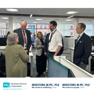 The Permanent Secretary to the Department of Health and members of the BSO Information Technology Services Senior Management Team speak with an ITS staff member in an open-plan office at James House. The visit provided an opportunity to learn more about the digital services and support ITS delivers across Health and Social Care in Northern Ireland.